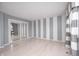 Bright bedroom featuring light wood flooring, neutral walls, and a mirrored closet at 303 E County Road 500 N, Pittsboro, IN 46167