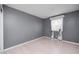 This empty bedroom offers gray walls, light floors, and a window to personalize as your own at 303 E County Road 500 N, Pittsboro, IN 46167
