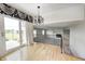 Bright dining area with hardwood floors, modern chandelier, access to the deck, and an open floor plan at 303 E County Road 500 N, Pittsboro, IN 46167
