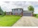 Charming two-story home with well-manicured front yard and attached two-car garage at 303 E County Road 500 N, Pittsboro, IN 46167