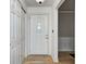 Bright foyer with white front door, hardwood floors, closet, and access to other rooms at 303 E County Road 500 N, Pittsboro, IN 46167