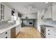 Open kitchen with stainless steel appliances and a view into the living room at 303 E County Road 500 N, Pittsboro, IN 46167
