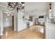 Bright kitchen featuring white cabinets, stainless steel appliances, and hardwood floors at 303 E County Road 500 N, Pittsboro, IN 46167