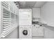 Efficient laundry area features a stacked washer and dryer, along with built-in cabinets for storage at 303 E County Road 500 N, Pittsboro, IN 46167