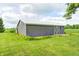 Storage shed with a sliding barn door and well-maintained lawn at 303 E County Road 500 N, Pittsboro, IN 46167