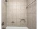Tiled shower and tub combo with inset shelves and updated fixtures at 303 E County Road 500 N, Pittsboro, IN 46167