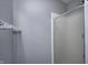 Shower with glass door, chrome towel rack, and light gray walls at 303 E County Road 500 N, Pittsboro, IN 46167