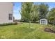 Lush backyard featuring a shed, patio seating area, and a well-maintained lawn at 360 Myers Lake Dr, Noblesville, IN 46062