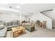 Large, carpeted basement featuring ample seating, neutral walls, and natural light from a window at 360 Myers Lake Dr, Noblesville, IN 46062