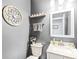 Stylish powder room with gray walls, decorative mirror, modern vanity, and decorative wall art at 360 Myers Lake Dr, Noblesville, IN 46062