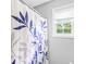 Cozy bathroom interior showing the bath tub with a vibrant shower curtain and window at 360 Myers Lake Dr, Noblesville, IN 46062