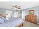 This bedroom features blue painted walls and dark wooden furniture, creating a serene and elegant living space at 360 Myers Lake Dr, Noblesville, IN 46062