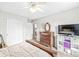 Spacious bedroom with carpet, closet, dresser, and TV showcasing the home's comfort and storage at 360 Myers Lake Dr, Noblesville, IN 46062