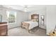 Serene bedroom with natural light, classic wood bed frame, and neutral tones for relaxation at 360 Myers Lake Dr, Noblesville, IN 46062
