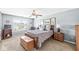 Bedroom showcasing a spacious layout with a wooden bed frame, complemented by elegant blue walls and soft lighting at 360 Myers Lake Dr, Noblesville, IN 46062