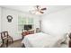 This bedroom features a comfy bed with a white comforter, a ceiling fan, and a window for natural light at 360 Myers Lake Dr, Noblesville, IN 46062