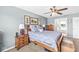 This bedroom features blue painted walls, a wooden bed, and is decorated with framed pictures at 360 Myers Lake Dr, Noblesville, IN 46062