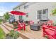 Outdoor deck featuring comfortable seating, a fire pit, and an umbrella for shade at 360 Myers Lake Dr, Noblesville, IN 46062