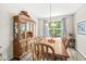 Traditional dining room with a large window, chandelier, and wooden china cabinet at 360 Myers Lake Dr, Noblesville, IN 46062