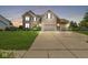 Two-story home with a well-manicured lawn, brick and siding exterior, and a three-car garage, creating curb appeal at 360 Myers Lake Dr, Noblesville, IN 46062