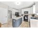 Spacious kitchen with white cabinets, stainless steel appliances, and a gray center island at 360 Myers Lake Dr, Noblesville, IN 46062