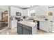 Bright kitchen featuring a gray island, white cabinets, and modern appliances at 360 Myers Lake Dr, Noblesville, IN 46062