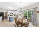 Bright kitchen features white cabinets, a blue island, stainless appliances, and a dining area with sliding glass doors at 360 Myers Lake Dr, Noblesville, IN 46062
