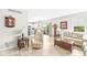 Bright living room with neutral decor, including two sofas, a recliner, and views of the kitchen and backyard at 360 Myers Lake Dr, Noblesville, IN 46062