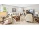 Cozy living room offers neutral paint, comfortable furniture, a fireplace, and a large window for ample natural light at 360 Myers Lake Dr, Noblesville, IN 46062