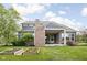 Spacious backyard with a well-maintained lawn, covered patio, and garden beds at 3720 Abney Highland Dr, Zionsville, IN 46077