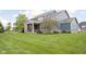 Expansive backyard featuring lush green lawn, covered patio, and attractive landscaping at 3720 Abney Highland Dr, Zionsville, IN 46077