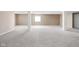 Finished basement with neutral walls, plush carpeting, and decorative columns at 3720 Abney Highland Dr, Zionsville, IN 46077