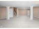 Open basement with carpeting, white support pillars, and staircase at 3720 Abney Highland Dr, Zionsville, IN 46077