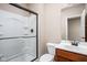 Bathroom featuring a sliding glass shower door, toilet, and sink with wood cabinets at 3720 Abney Highland Dr, Zionsville, IN 46077
