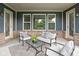 Charming covered patio featuring comfortable seating, a glass coffee table, and outdoor living space at 3720 Abney Highland Dr, Zionsville, IN 46077