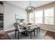 Dining area features a modern chandelier and ample natural light at 3720 Abney Highland Dr, Zionsville, IN 46077