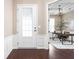Elegant foyer with dark hardwood floors, white wainscoting, and study view at 3720 Abney Highland Dr, Zionsville, IN 46077