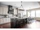Modern kitchen with large center island, bar stool seating, stainless appliances and an adjacent dining area at 3720 Abney Highland Dr, Zionsville, IN 46077