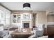 Bright living room featuring fireplace, built-in shelving, and hardwood floors at 3720 Abney Highland Dr, Zionsville, IN 46077