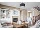 Bright living room featuring fireplace, built-in shelving, and hardwood floors at 3720 Abney Highland Dr, Zionsville, IN 46077