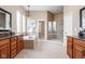 Luxurious main bathroom with dual vanities, a soaking tub, and a glass-enclosed shower at 3720 Abney Highland Dr, Zionsville, IN 46077