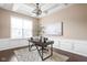 Well-lit home office with tray ceiling, wainscoting, large windows, and modern decor at 3720 Abney Highland Dr, Zionsville, IN 46077