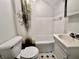 Bathroom with a toilet, sink vanity and shower with decorative tree-themed shower curtain at 388 N Ohio St, Martinsville, IN 46151