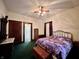 Warm bedroom with a brass bed, a wood dresser, and an attached bathroom with a glass door shower at 388 N Ohio St, Martinsville, IN 46151