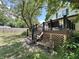 Back deck with stairs that leads to a backyard with a park bench and mature trees that offer shade at 388 N Ohio St, Martinsville, IN 46151