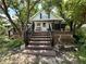 Charming front entrance with a wooden staircase leading to a cozy porch and inviting home at 388 N Ohio St, Martinsville, IN 46151