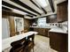 Farmhouse kitchen with dark wood cabinets, white countertops, and a built-in dining table at 388 N Ohio St, Martinsville, IN 46151