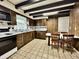 Kitchen with tiled floors, paneled walls, matching cabinets, and a kitchen dining table at 388 N Ohio St, Martinsville, IN 46151