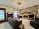 Spacious living room with a brick fireplace, rocking chair and comfortable seating at 388 N Ohio St, Martinsville, IN 46151