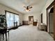 Spacious living room with large window, a ceiling fan, light colored carpet, and view to another room at 388 N Ohio St, Martinsville, IN 46151